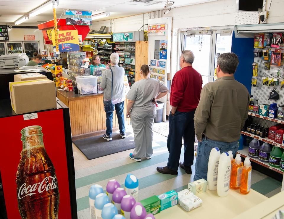Customers wait in line to purchase Mega Millions lottery tickets at Bodie's Dairy Market in Millsboro in 2018.