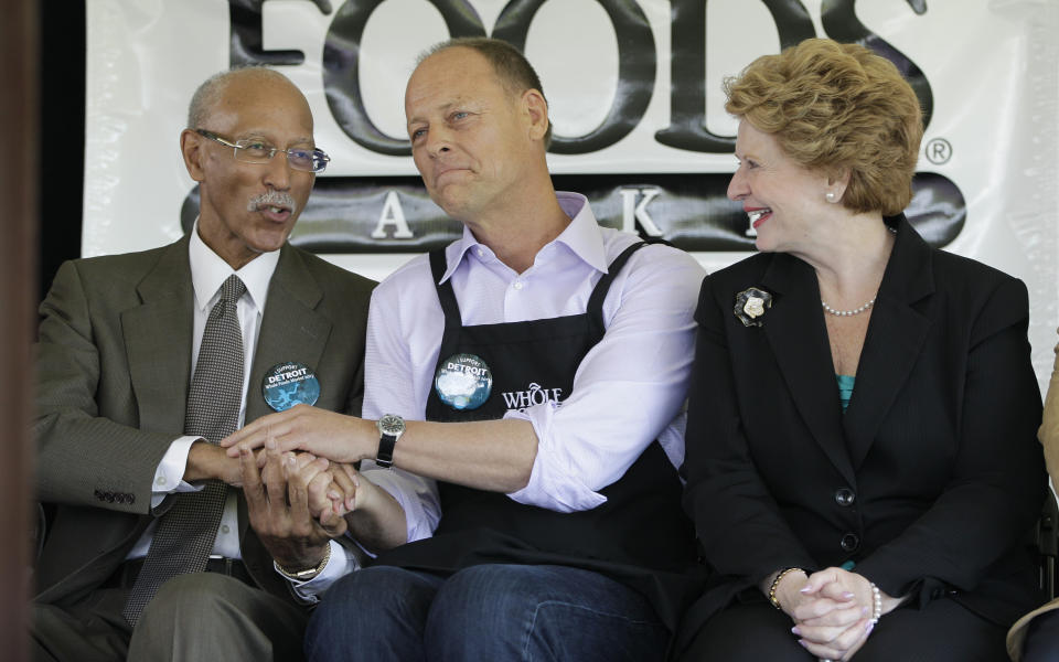 Detroit Mayor Dave Bing, left, and Whole Foods Market co-CEO Walter Robb shake hands as Sen. Debbie Stabenow, D-Mich., watches during a ground breaking ceremony for the retailer in Detroit, Monday, May 14, 2012. The Austin, Texas-based retailer plans to open a 20,000-square-foot supermarket with about 75 employees next year. The company began looking at Midtown in 2010. (AP Photo/Carlos Osorio)