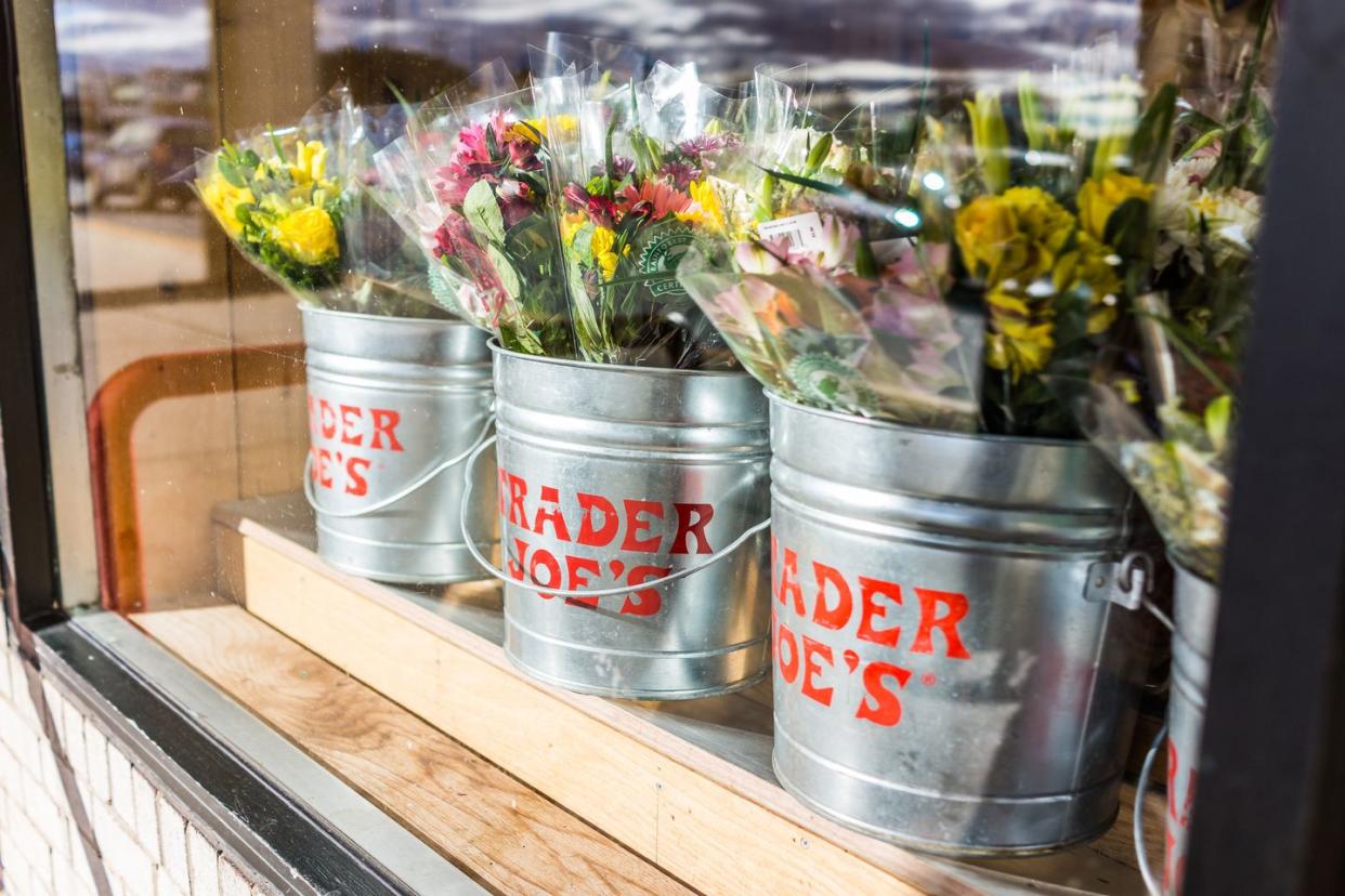 fairfax buckets of flowers with trader joes signs viewed from outside of store