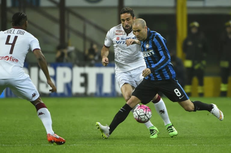 Inter Milan's forward Rodrigo Palacio (R) fights for the ball with Torino's midfielder Joel Chukwuma Obi (L) on April 3, 2016