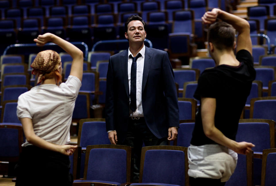 Craig Revel Horwood goes over dance moves with dancers during rehearsals for 