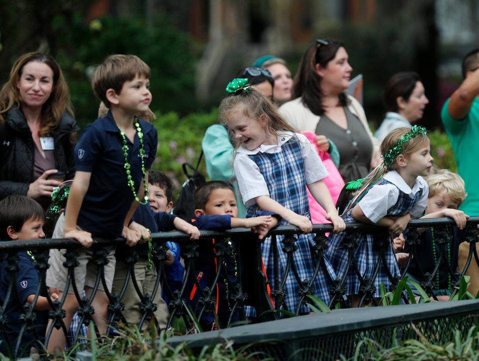 Students from St. James Catholic School line up along the fence around the fountain as they await the start of the annual Greening of the Fountain on Friday March 10, 2023 at Forsyth Park.