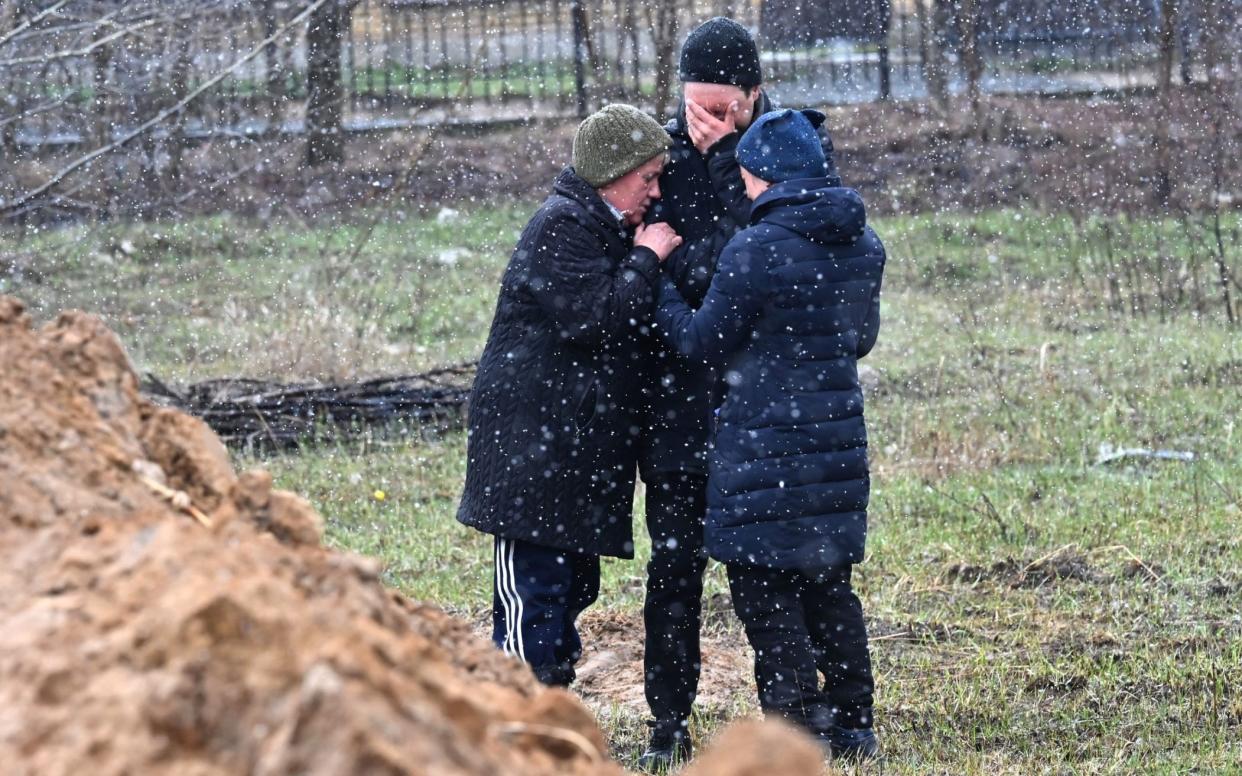 People at a mass grave in Bucha, north-west of Kyiv. Vladislav Kozlovsky has told how people in the town were shot by the Russians - Sergei Supinsky/AFP via Getty Images