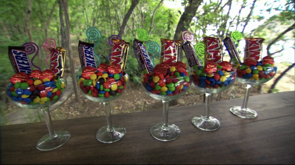 A line of glasses holding Mars Chocolate products