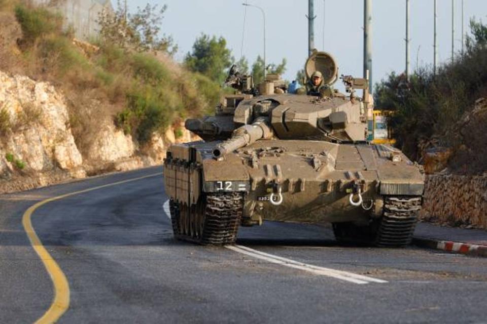 An Israeli army Merkava tank blocks one of the entrances to the northern Israeli kibbutz of Misgav Am near the border with Lebanon on 10 October 2023 (AFP via Getty Images)