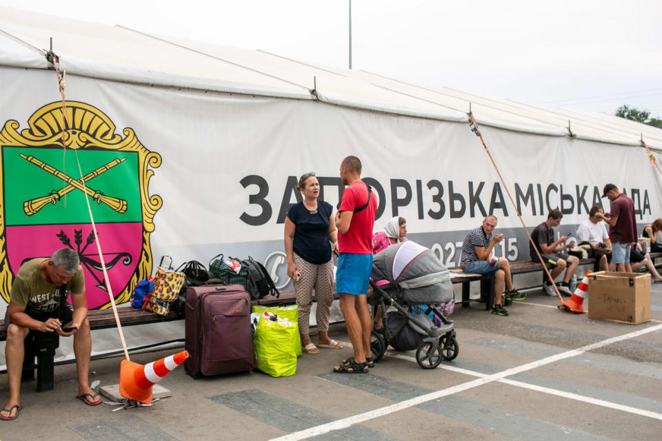 <div class="inline-image__caption"><p>Serhii, 30, (red shirt) an electrical engineer who used to work at the Zaporizhzhya nuclear plant, waiting with his wife and baby at a humanitarian center before he takes a bus with his family to Kyiv. He said he decided to leave his work for his family’s safety.</p></div> <div class="inline-image__credit">Asmaa Waguih</div>