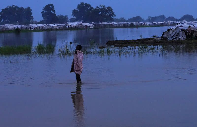 A displaced child wades through floodwaters after the River Nile broke the dykes in Pibor