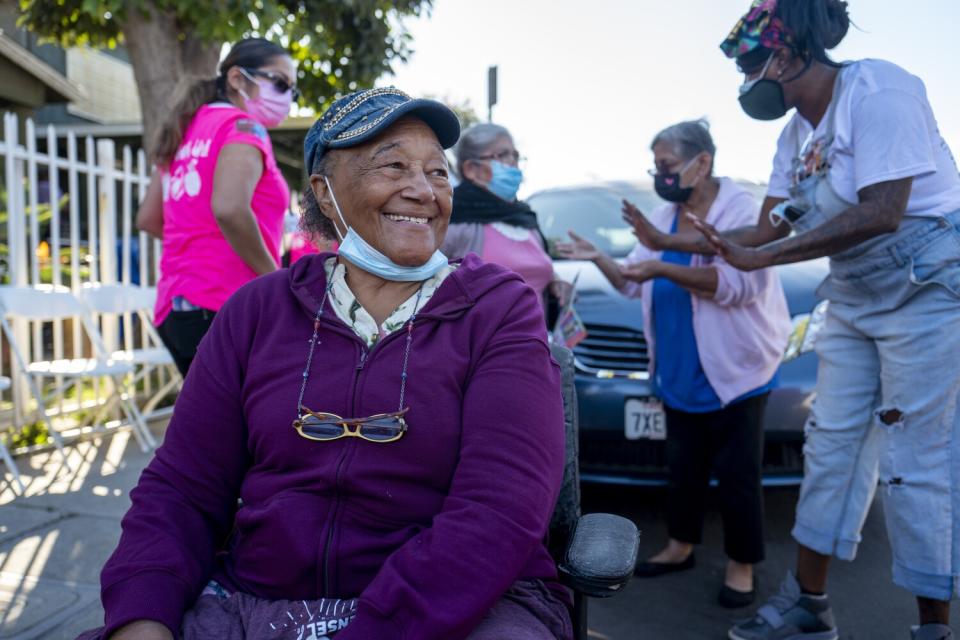 A woman smiles during a food giveaway.