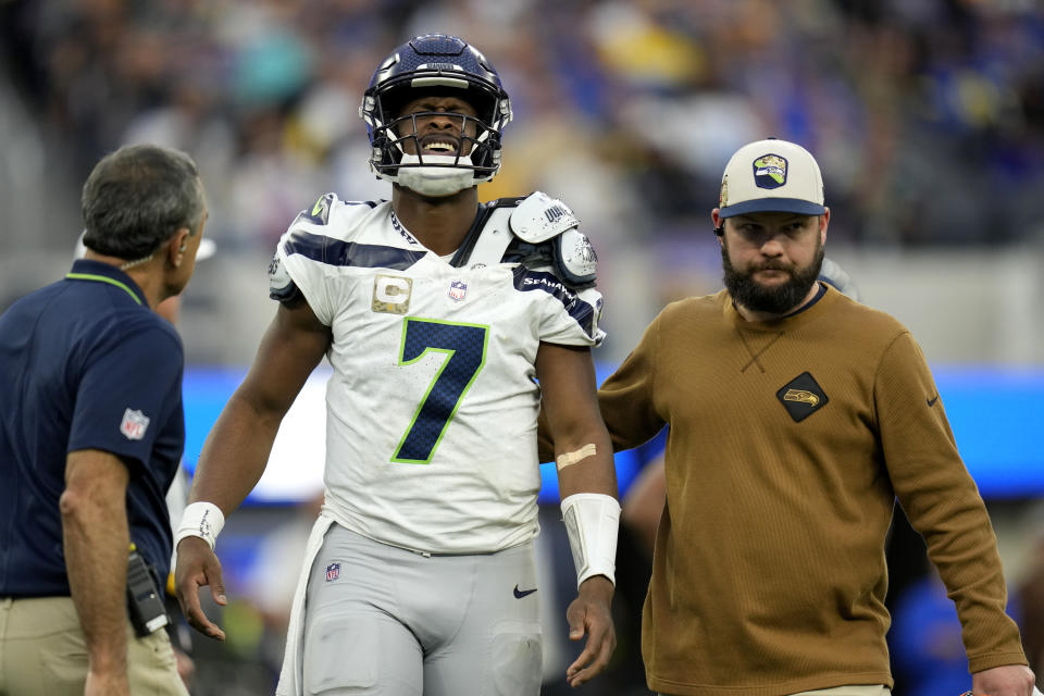 Seattle Seahawks quarterback Geno Smith (7) is helped off the field after an injury during the second half of an NFL football game against the Los Angeles Rams Sunday, Nov. 19, 2023, in Inglewood, Calif. (AP Photo/Ashley Landis)