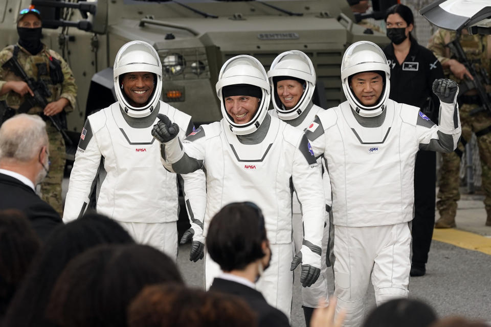 Astronauts, from left, Victor Glover, Michael Hopkins, Shannon Walker, and Japan Aerospace Exploration Agency astronaut Soichi Noguchi wave to family members as they leave the Operations and Checkout Building for a trip to Launch Pad 39-A and planned liftoff on a SpaceX Falcon 9 rocket with the Crew Dragon capsule on a six-month mission to the International Space Station Sunday, Nov. 15, 2020, at the Kennedy Space Center in Cape Canaveral, Fla. (AP Photo/John Raoux)