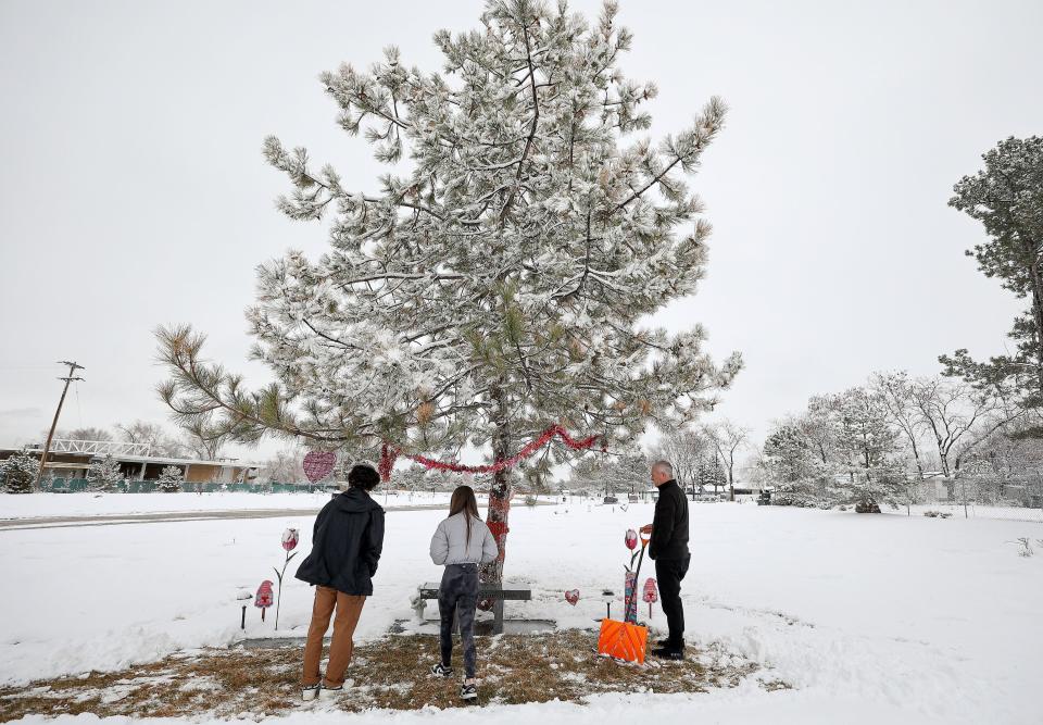 Acen Hunsaker, Hayden Hunsaker and their father Matt Hunsaker visit the grave of their grandmother and mother Maurine Hunsaker, who was murdered in 1986, at Valley View Memorial Park in West Valley City on Friday, Feb. 9, 2024. | Kristin Murphy, Deseret News