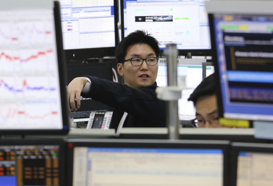 A currency trader gestures at the foreign exchange dealing room of the KEB Hana Bank headquarters in Seoul, South Korea, Monday, Dec. 17, 2018. Asian markets rose Monday on hopes that the Federal Reserve would re-evaluate its hawkish stance at a meeting later this week, following signs of slower global growth.(AP Photo/Ahn Young-joon)