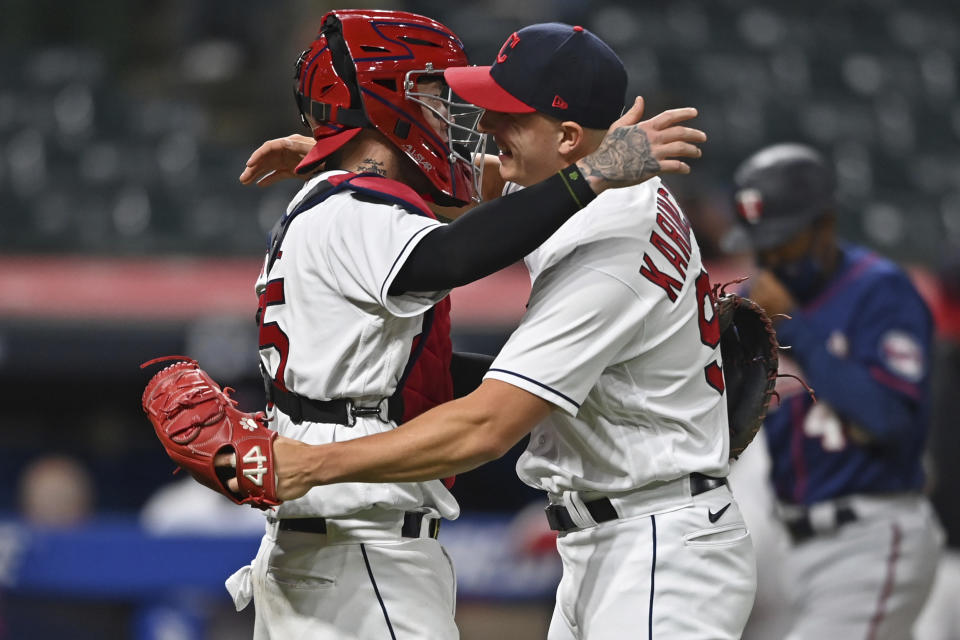 Cleveland Indians' relief pitcher James Karinchak (99) is congratulated by catcher Roberto Perez after the Indians defeated the Minnesota Twins in a baseball game, Tuesday, April 27, 2021, in Cleveland. (AP Photo/David Dermer)