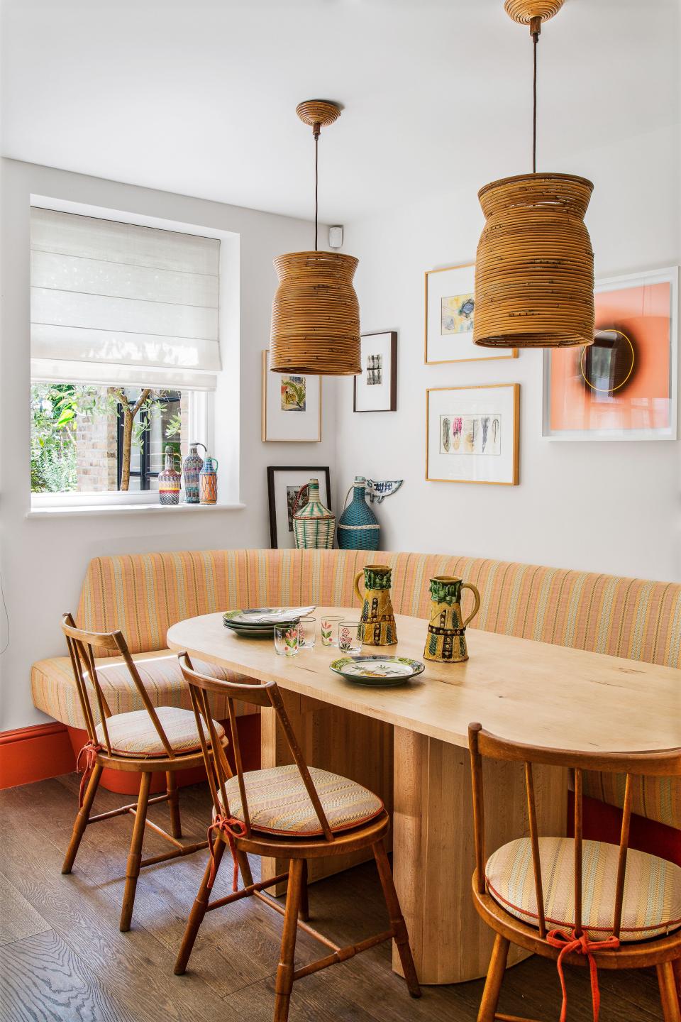 In the kitchen, Børge Mogensen chairs surround a Lely timber table. Vintage bamboo pendants.