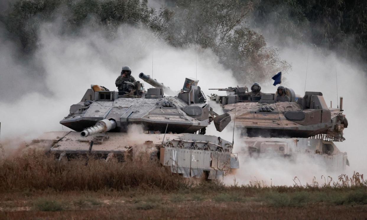 <span>Israeli tanks manoeuvre near the Gaza border on Thursday.</span><span>Photograph: Amir Cohen/Reuters</span>