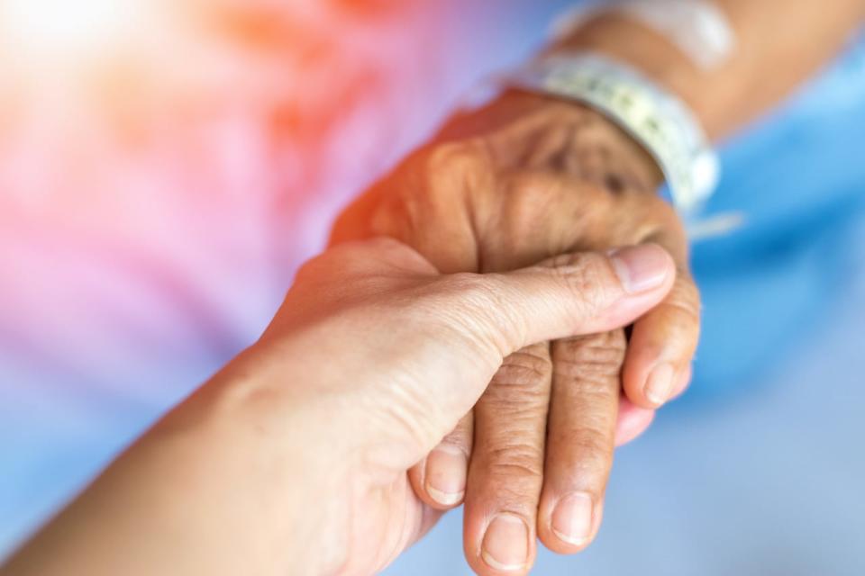 Geriatric doctor or geriatrician concept. Doctor physician hand on happy elderly senior patient to comfort in hospital examination room or hospice nursing home or wellbeing county. Stock Photo ID: 1504465982