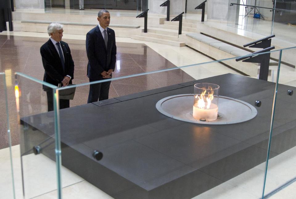 President Barack Obama and Nobel Peace Prize laureate and Holocaust survivor Elie Wiesel stop for a moment of silence in the Hall of Remembrance as they toured the Holocaust Memorial Museum in Washington, Monday, April 23, 2012. (AP Photo/Carolyn Kaster)