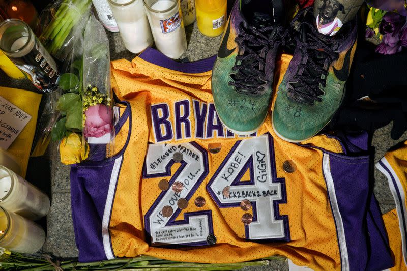 FILE PHOTO: Memorabilia and candles sit in Microsoft Square near the Staples Center to pay respects to Kobe Bryant after a helicopter crash killed the retired basketball star