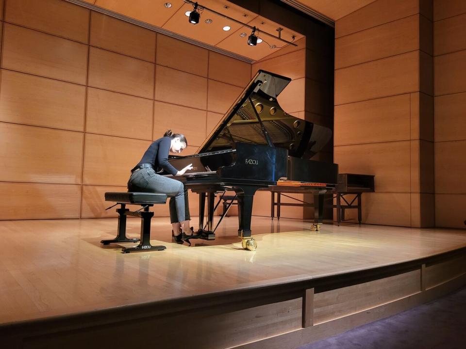 Olga Kudriakova plays the fully restored Fazioli concert grand piano on Wednesday. It was the first time anybody had performed on the instrument since it had been repaired. (Kwabena Oduro/CBC - image credit)