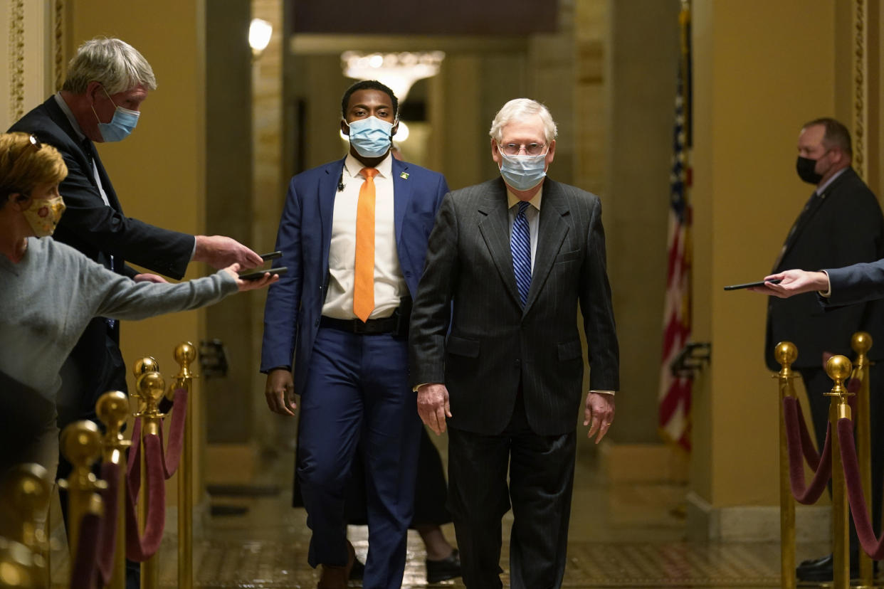 Senate Majority Leader Mitch McConnell of Ky., walks past reporters on Capitol Hill in Washington, Tuesday, Dec. 15, 2020. (AP Photo/Susan Walsh)