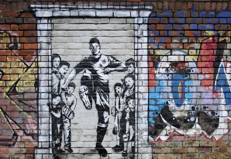 A mural of England soccer player Marcus Rashford kicking down the door of number 10 Downing Street appears on Manchester Canal in Manchester