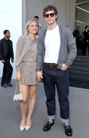<p>Victor Boyko/Getty</p> Natalie Engle and Evan Peters hold hands at the Prada fashion show on June 16, 2024