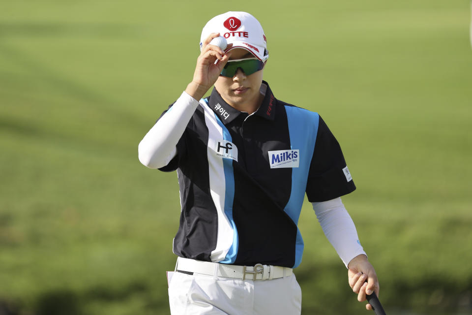 Hyo Joo Kim, of South Korea, waves to the gallery on the 11th green during the first round of the LPGA golf tournament on Wednesday, April 12, 2023, near Honolulu. (AP Photo/Marco Garcia)