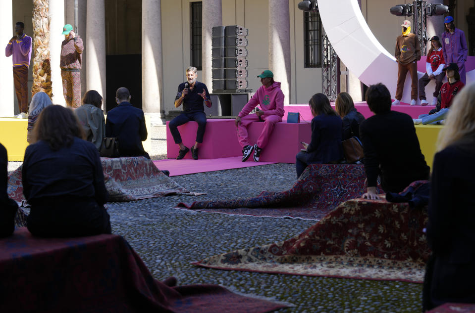 Benetton CEO Massimo Renon, left, speaks during a press conference with Italian rapper Ghali during a presentation of the Benetton women's and men's Spring Summer 2022 collection, unveiled during the Milan Fashion Week, in Milan, Italy, Tuesday, Sept. 21, 2021. (AP Photo/Antonio Calanni)