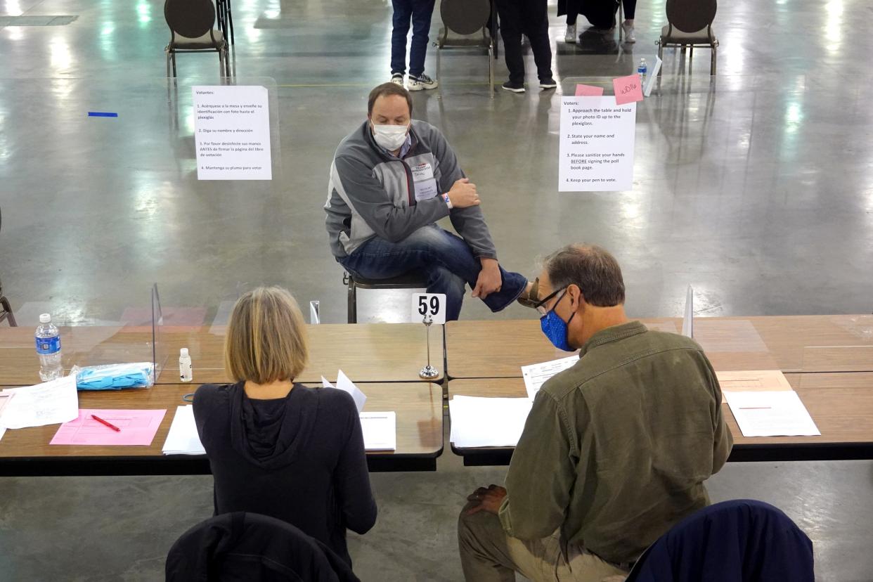 An election observer watches Wisconsin officials perform a recount of votes. (Getty Images)