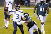 Seattle Seahawks' Russell Wilson (3) tries to get away from Philadelphia Eagles' Javon Hargrave (93) during the second half of an NFL football game, Monday, Nov. 30, 2020, in Philadelphia. (AP Photo/Chris Szagola)