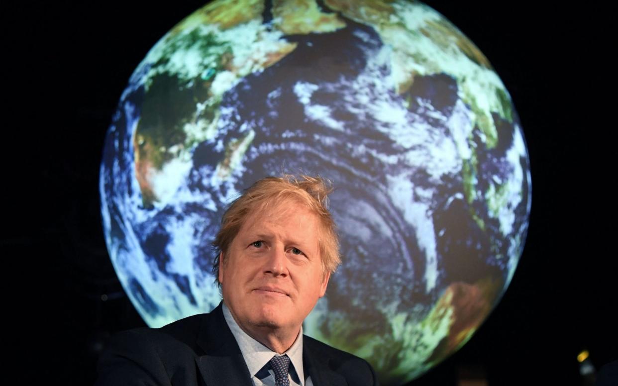 Boris Johnson, the Prime Minister, is expected to deliver the new climate pledge on Friday - AFP