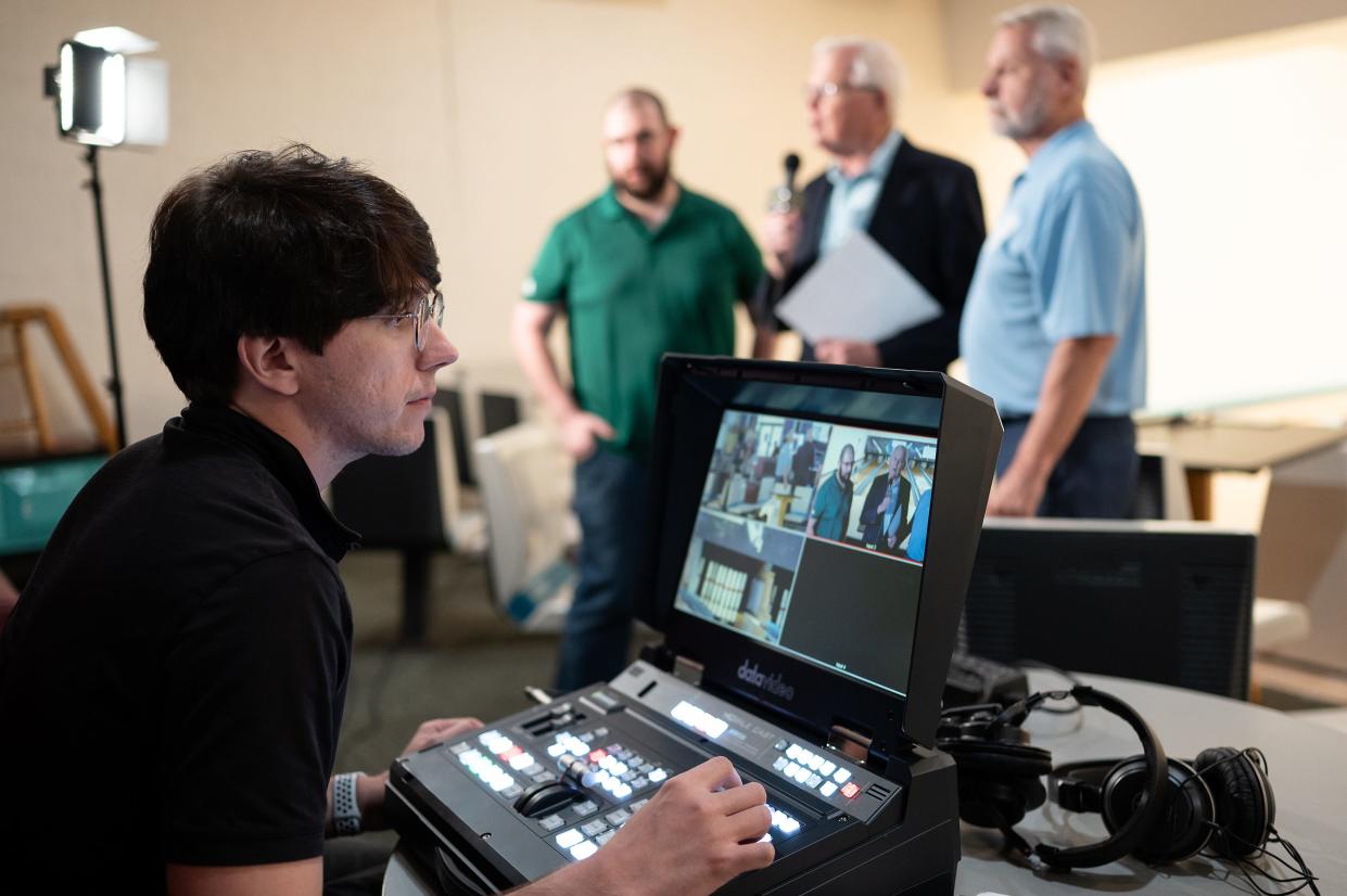 Tyler James, director, runs the equipment during "Bowling for Scholars" a TV program that raises money for college students hosted at Sparetime Recreation in Whitinsville on Thursday.