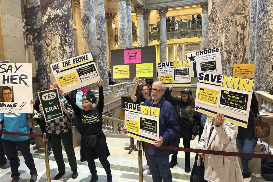 Protesters demanding the resignation of state Sen. Nicole Mitchell, D-Woodbury, gather outside the Minnesota Senate chamber in the State Capitol on Thursday, May 2, 2024, in St. Paul, Minn. Mitchell has been charged with burglary for breaking into her estranged stepmother's home. Amid the partisan rancor over her arrest, a bill to legalize sports betting in Minnesota, which requires bipartisan support, is now in serious trouble. (AP Photo/Steve Karnowski)