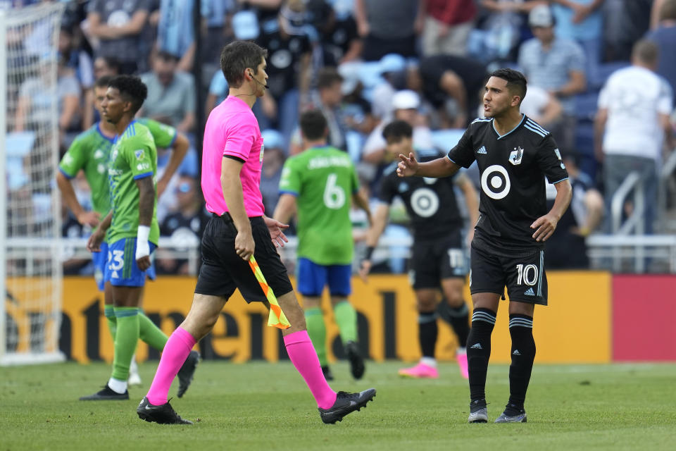 Minnesota United midfielder Emanuel Reynoso (10), right, reacts towards a referee after the 1-1 draw against the Seattle Sounders of an MLS soccer match, Sunday, Aug. 27, 2023, in St. Paul, Minn. (AP Photo/Abbie Parr)