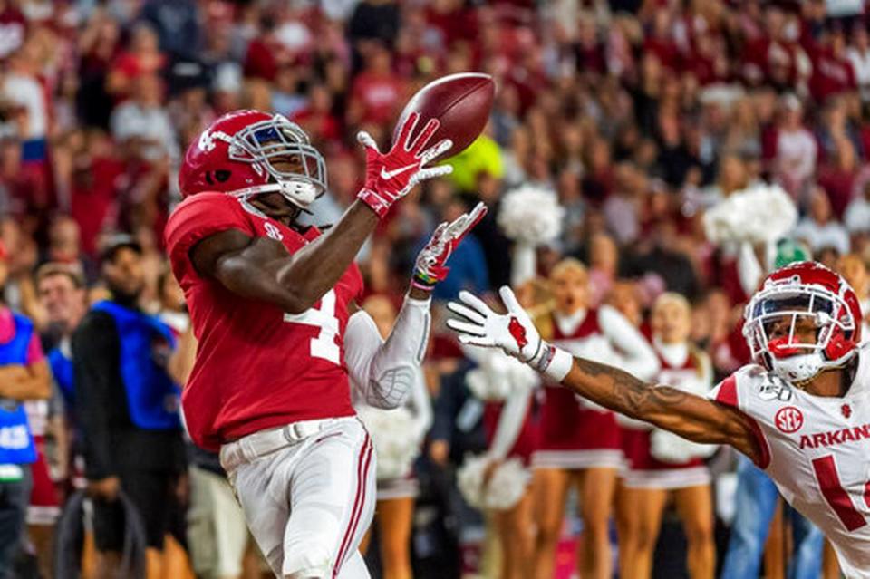 FILE - In this Oct. 26, 2019, file photo, Alabama wide receiver Jerry Jeudy (4) catches a touchdown pass against Arkansas during the second half of an NCAA college football game in Tuscaloosa, Ala. This year’s NFL draft features a superb group of wide receivers, including Jeudy, who are expected to make immediate impacts in the NFL.