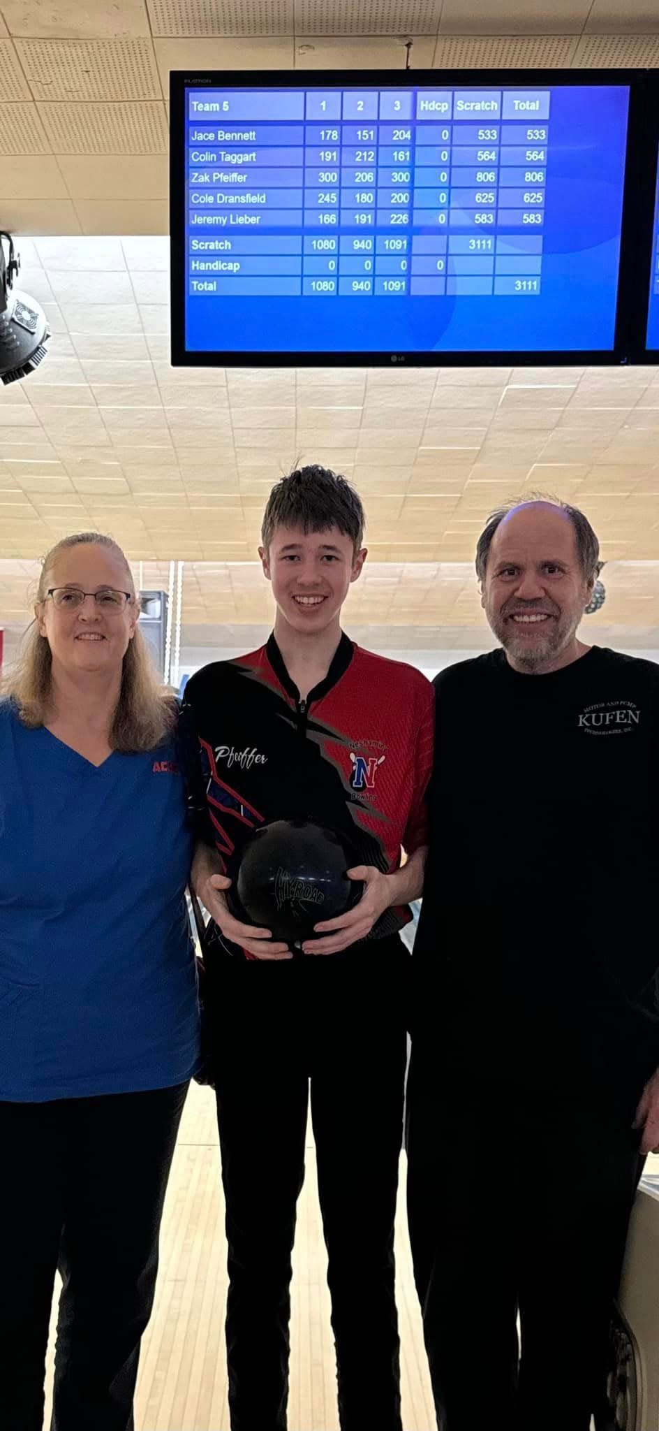 Neshaminy's Zak Pfeiffer (center) poses with his parents, Janet and Steve, after his historic afternoon.