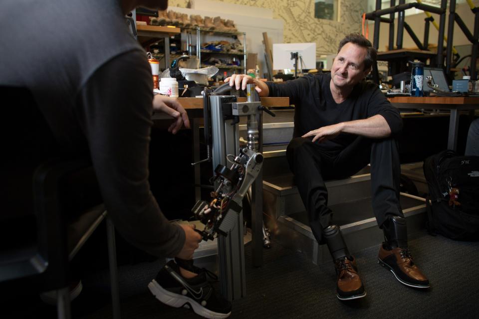 Hugh Herr in his research lab at the K. Lisa Yang Center for Bionics at MIT. Herr, a double-amputee himself, has helped develop a new approach to surgery and a bionic limb that he hopes will be commercially available within five years.