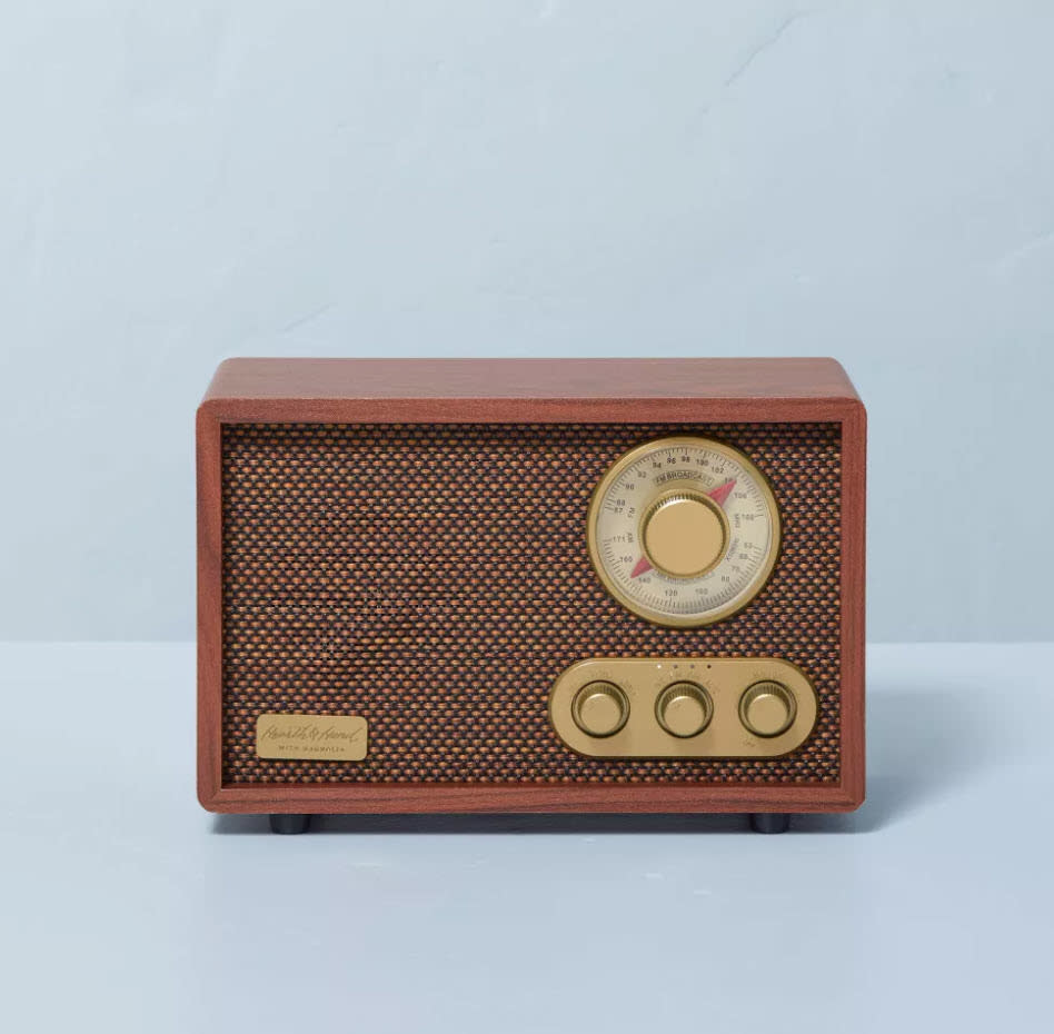 small old-school style box radio speaker with three dials in gold