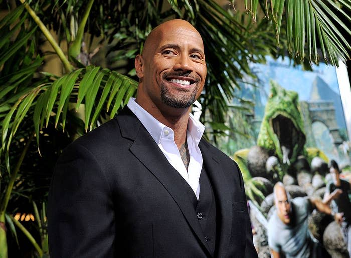 A closeup of Dwayne smiling at a red carpet premiere