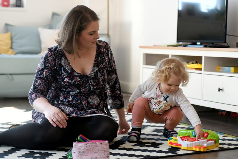 FILE PHOTO: Scharle plays with her daughter at their home in Budakeszi, a western suburb of Budapest
