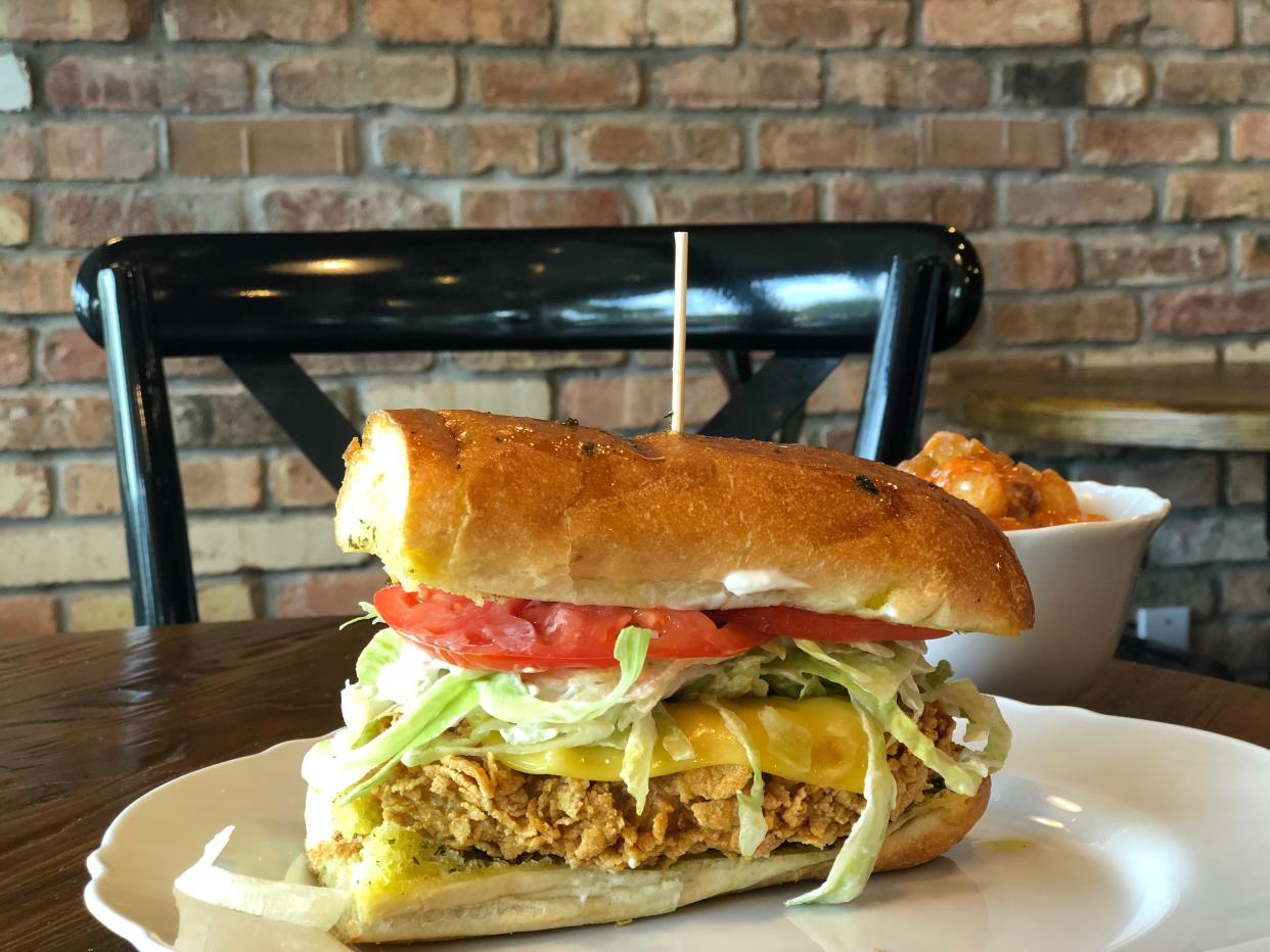 The Plant-Based Mafia's "Long G'Islander" sandwich stacks a fried vegan chicken cutlet  with fixings on a toasted garlic hoagie bun. The vegan restaurant is in Palm Beach Gardens.