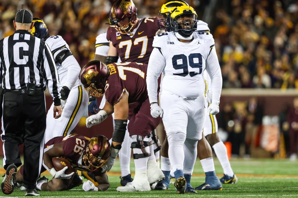 Michigan Wolverines defensive lineman Cam Goode (99) celebrates a tackle against the Minnesota Golden Gophers during the second quarter at Huntington Bank Stadium in Minneapolis on Saturday, Oct. 7, 2023.