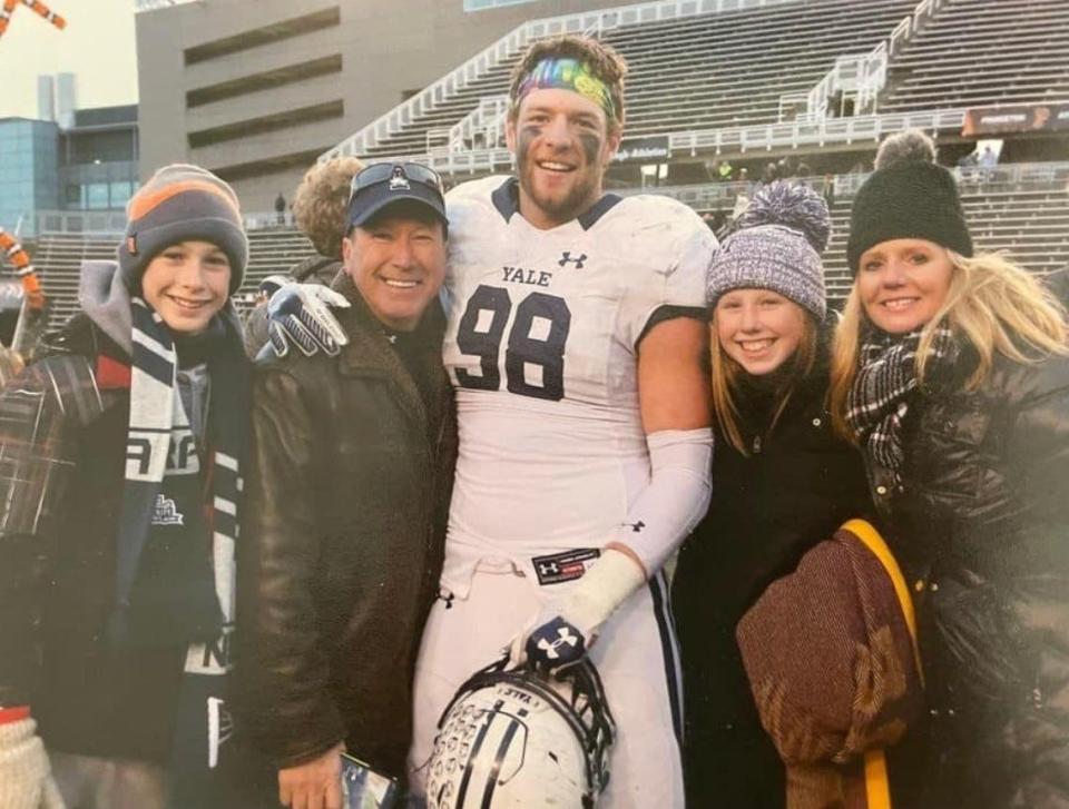 Kyle Mullen, while playing football at Yale, poses with family members at Princeton University.
