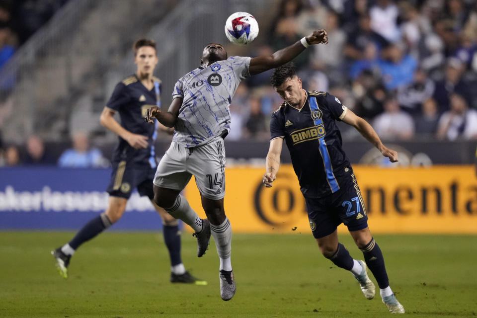 CF Montréal's Sunusi Ibrahim (14) and Philadelphia Union's Kai Wagner (27) battle for the ball during the second half of an MLS soccer match, Saturday, June 3, 2023, in Chester, Pa. (AP Photo/Matt Slocum)