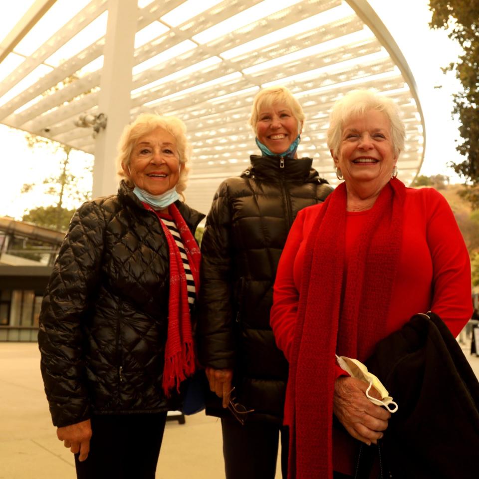 Three women pose for a photo.