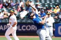 Jun 9, 2018; Oakland, CA, USA; Kansas City Royals first baseman Mike Moustakas (8) catches the ball for an out against Oakland Athletics first baseman Matt Olson (28) during the seventh inning at Oakland Coliseum. Mandatory Credit: Kelley L Cox-USA TODAY Sports
