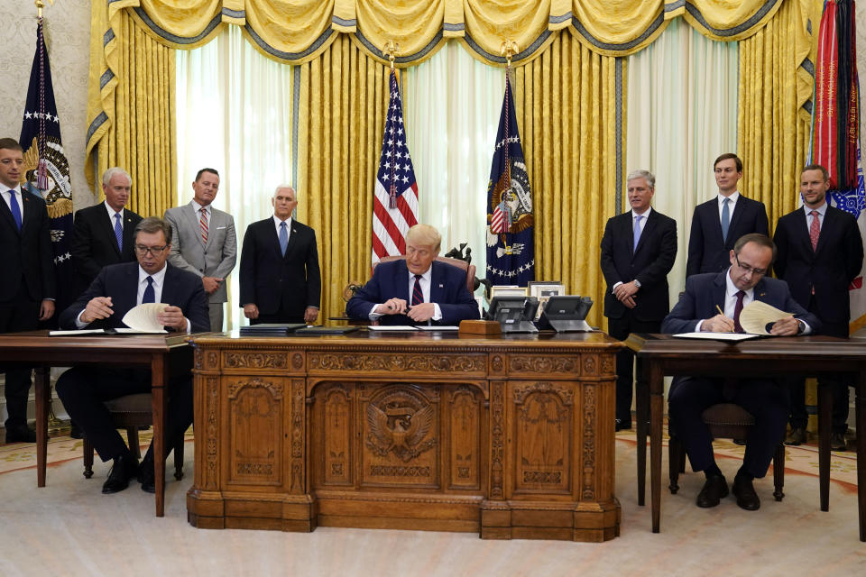 President Donald Trump participates in a signing ceremony with Serbian President Aleksandar Vucic, seated left, and Kosovar Prime Minister Avdullah Hoti, seated right, in the Oval Office of the White House, Friday, Sept. 4, 2020, in Washington. (AP Photo/Evan Vucci)