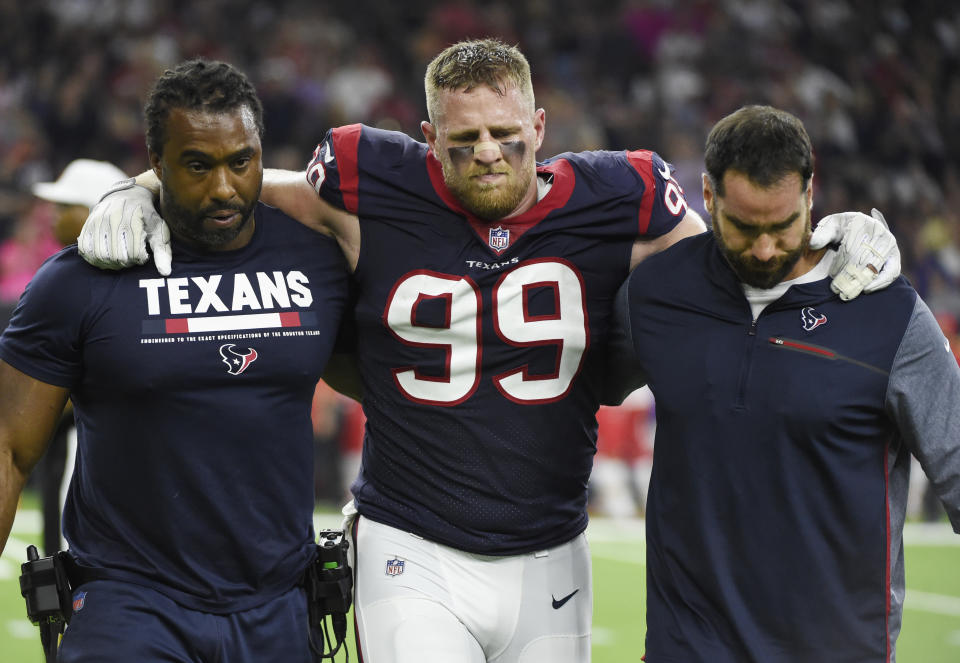 Houston Texans defensive end J.J. Watt (99) is helped off the field after he was injured during the first half against the Chiefs. (AP)