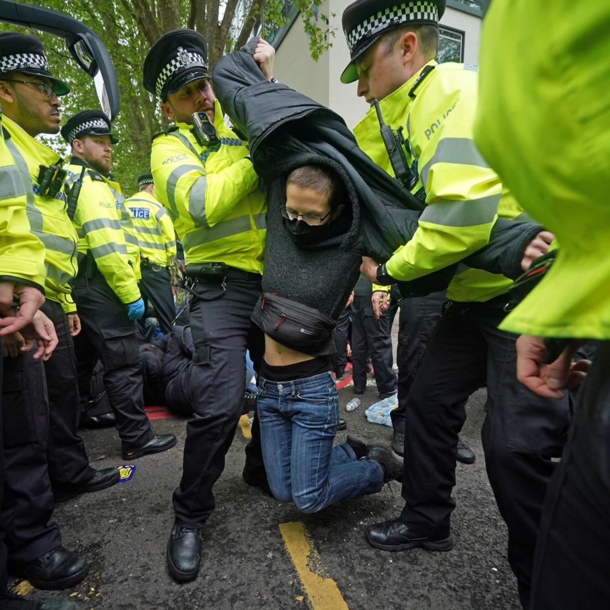 A protester struggling with officers