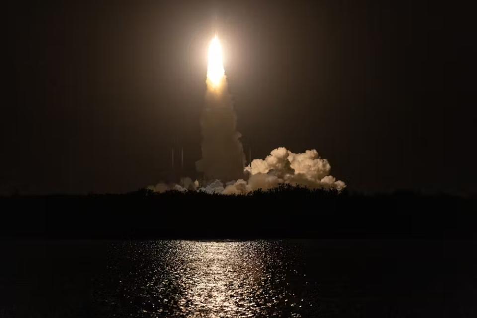 An image of a rocket lifting off. The color scheme is neutral sepia.